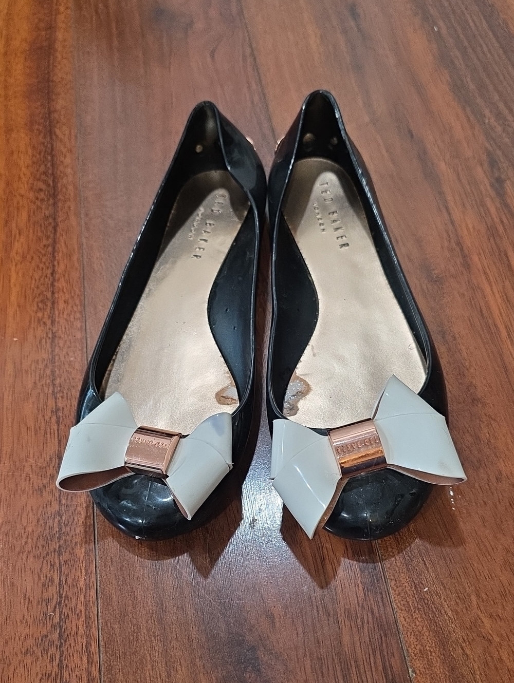 Ted Baker Julivia jelly flats in black with white bow And Rose Gold Accent